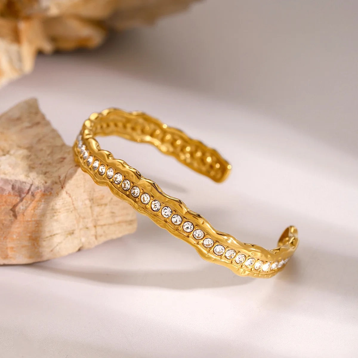 European-style hammered bracelet featuring brilliant-cut stones in a refined gold-plated finish.