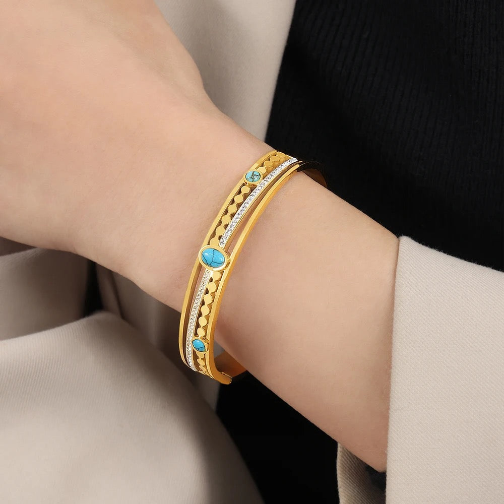 Stylish bracelet featuring a vibrant turquoise stone, set in a sleek gold-plated design