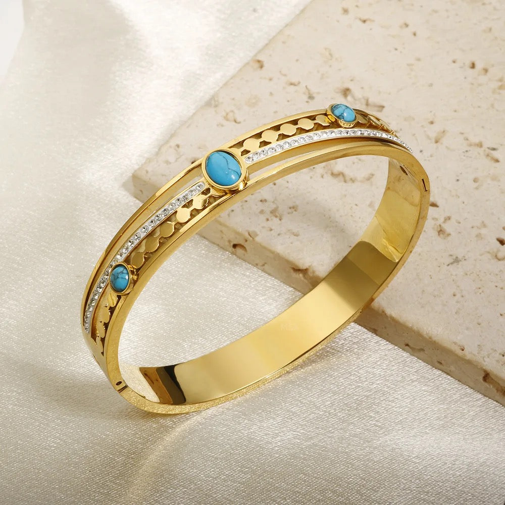 Stylish bracelet featuring a vibrant turquoise stone, set in a sleek gold-plated design