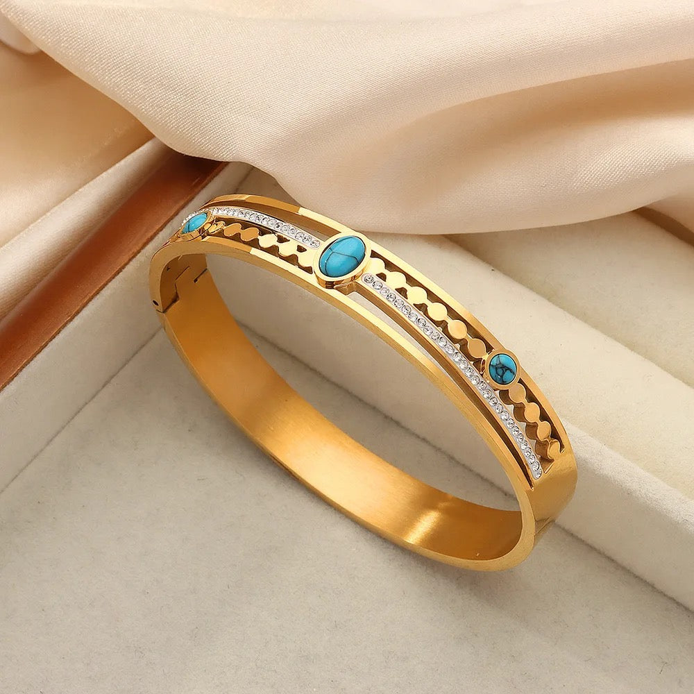 Stylish bracelet featuring a vibrant turquoise stone, set in a sleek gold-plated design